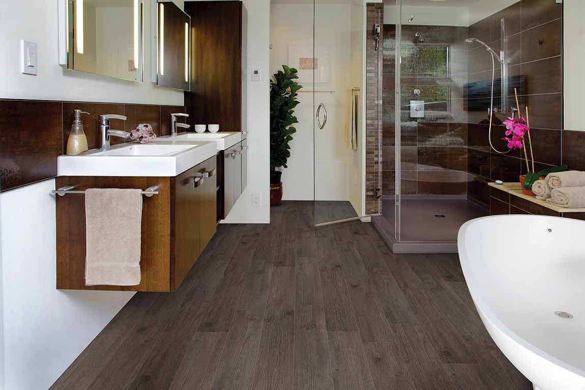 bathroom with lvt wood look flooring and floating vanity