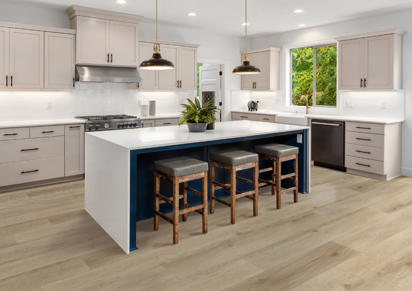 wood flooring in kitchen with kitchen island.